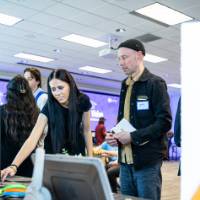 Professor Joel Potrykus with student looking at presentation